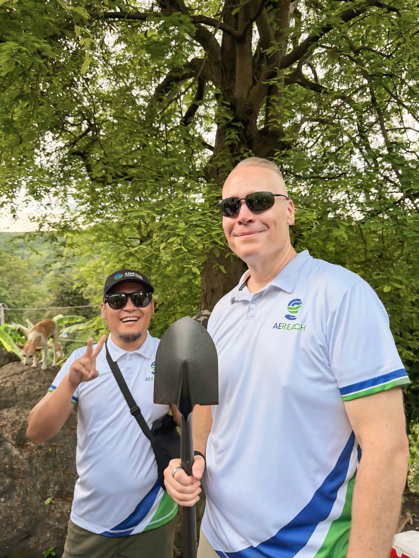Tim Bonnell with a spade under the trees at the planting site.